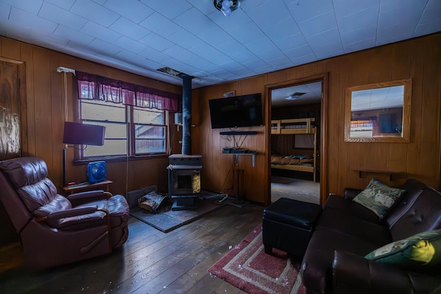 23790 360th St, Huntersville Twp, MN 56464 - living room featuring dark wood-type flooring, wooden walls, and a wood stove