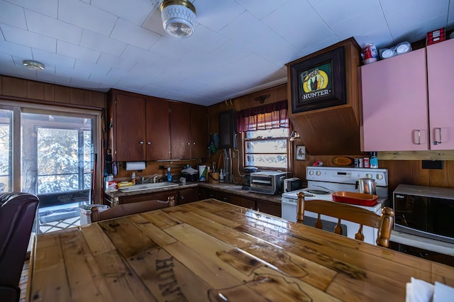 23790 360th St, Huntersville Twp, MN 56464 - kitchen with wood counters, sink, wooden walls, and white range with electric stovetop