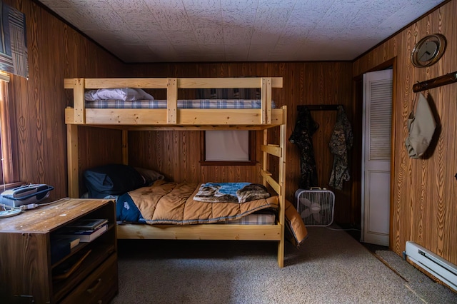 23790 360th St, Huntersville Twp, MN 56464 - bedroom featuring carpet floors, a baseboard radiator, and wood walls