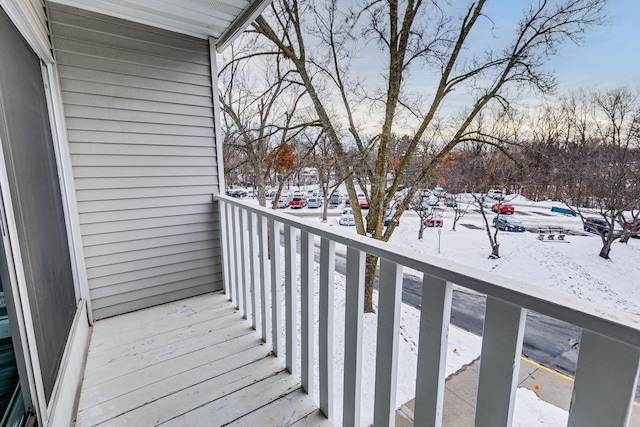 view of snow covered back of property