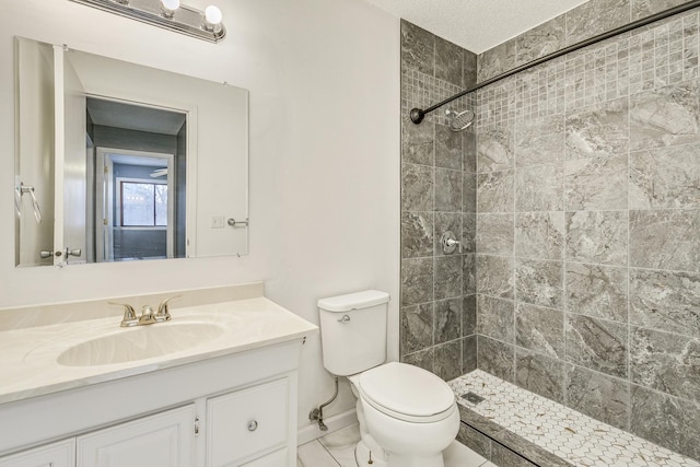 full bathroom featuring a stall shower, vanity, toilet, and baseboards