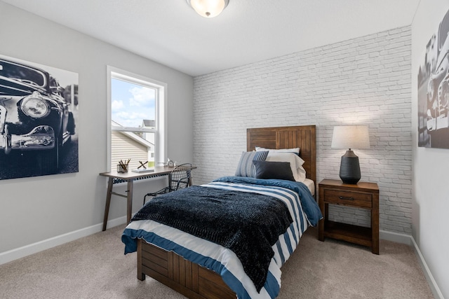 carpeted bedroom featuring brick wall