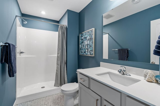 bathroom featuring toilet, vanity, and a shower with shower curtain