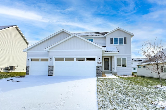 craftsman-style home featuring a garage and central air condition unit