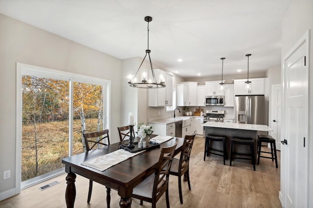 dining area featuring light hardwood / wood-style floors and sink