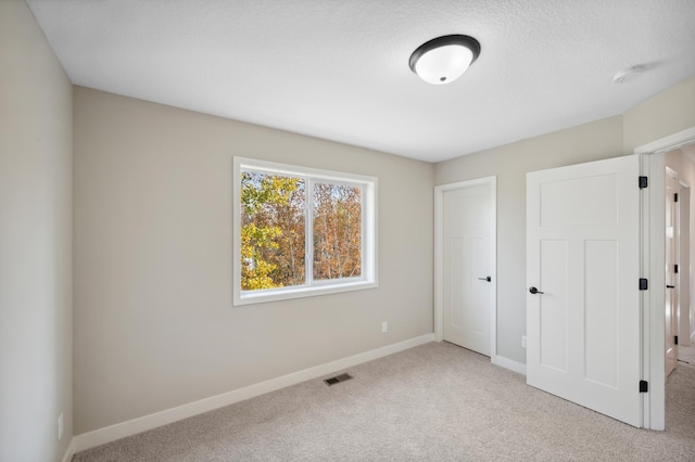 unfurnished bedroom with light carpet