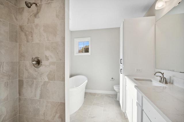 bathroom featuring vanity, a tile shower, and toilet