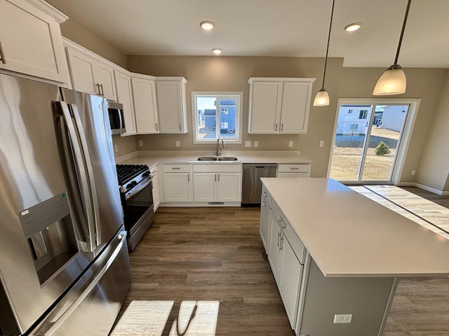 kitchen with stainless steel appliances, white cabinets, and a kitchen island