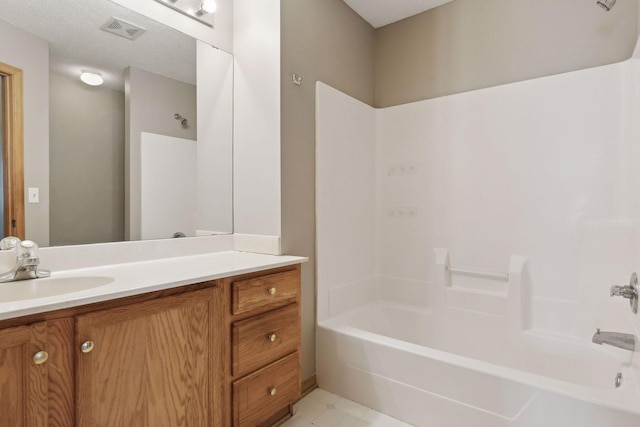 bathroom featuring shower / washtub combination and vanity