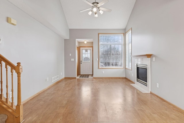 unfurnished living room featuring ceiling fan, light hardwood / wood-style flooring, and lofted ceiling