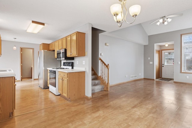 kitchen with light hardwood / wood-style floors, pendant lighting, and stainless steel appliances