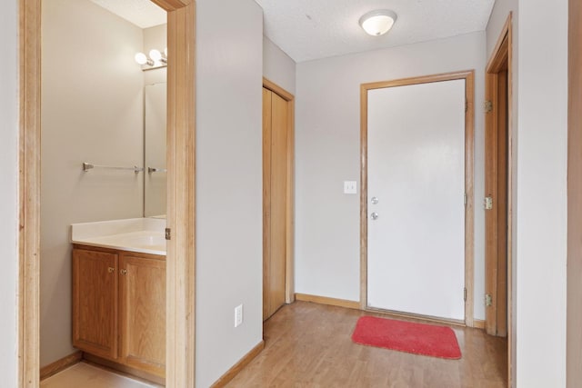 interior space featuring light hardwood / wood-style floors and a textured ceiling