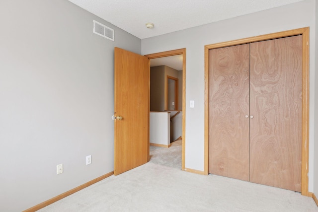 bedroom with light colored carpet and a closet