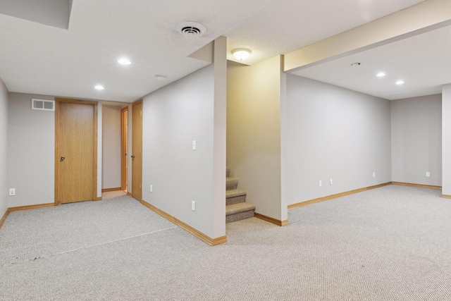 basement featuring light carpet