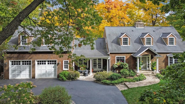 cape cod home with a garage