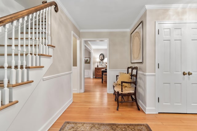 foyer with hardwood / wood-style flooring and ornamental molding