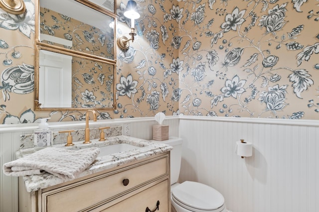 bathroom with toilet and vanity