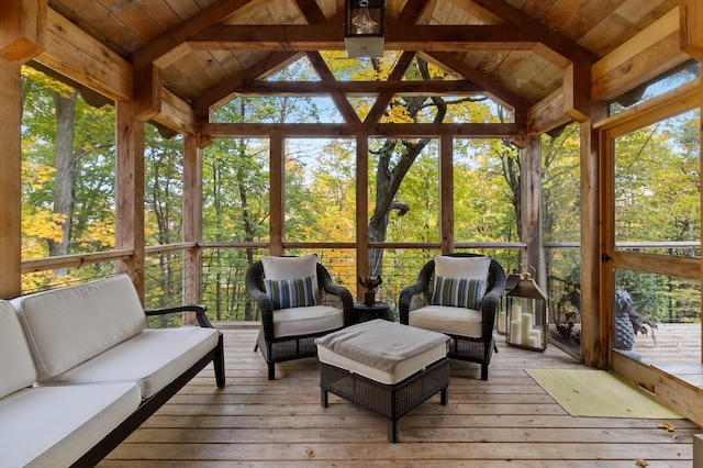 sunroom featuring lofted ceiling with beams, wood ceiling, and a healthy amount of sunlight