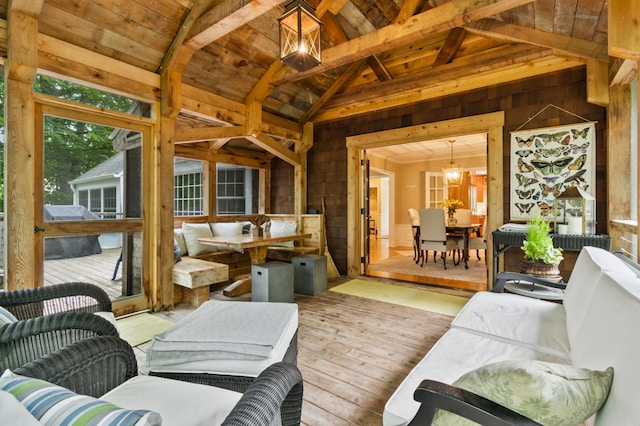 living room featuring hardwood / wood-style floors, wood ceiling, beamed ceiling, a notable chandelier, and high vaulted ceiling