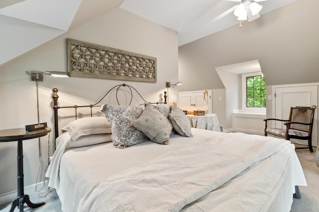 carpeted bedroom featuring vaulted ceiling and ceiling fan