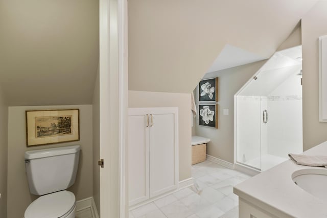 bathroom with toilet, a shower with door, vanity, and vaulted ceiling