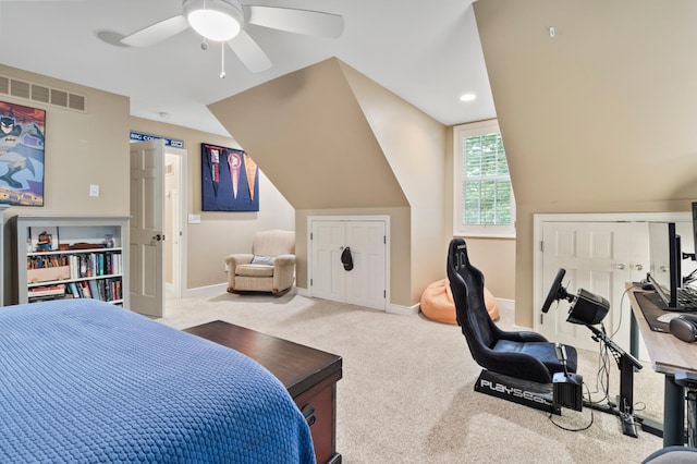 carpeted bedroom featuring ceiling fan, a closet, and vaulted ceiling