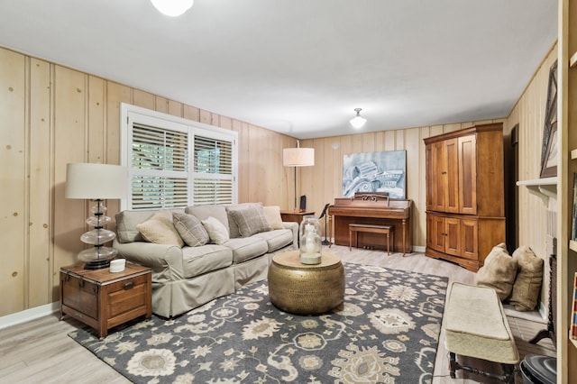 living room featuring wood walls and light hardwood / wood-style flooring