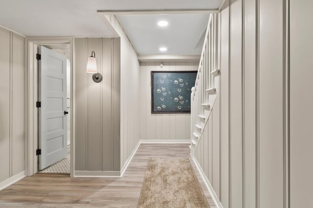 corridor with crown molding and light hardwood / wood-style flooring