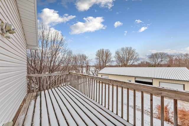 snow covered deck featuring a garage