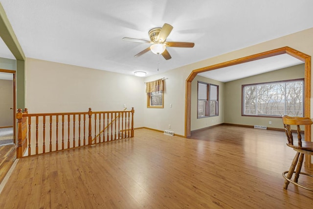 unfurnished room featuring vaulted ceiling, ceiling fan, and light wood-type flooring