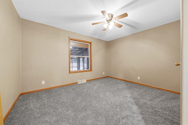 spare room featuring ceiling fan and carpet flooring