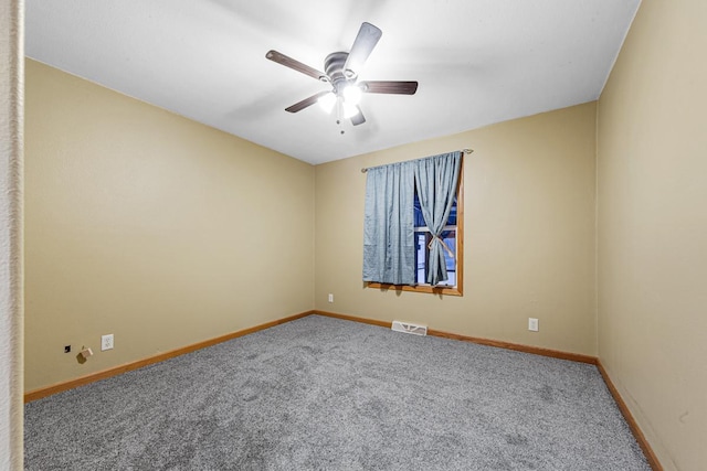 spare room featuring carpet floors and ceiling fan