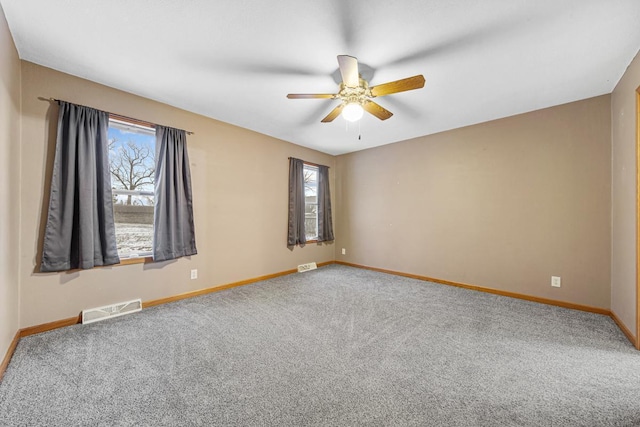 empty room with ceiling fan and carpet