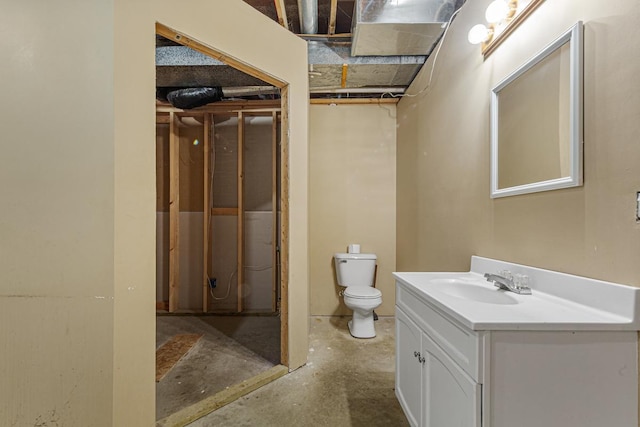 bathroom featuring toilet, concrete flooring, and vanity