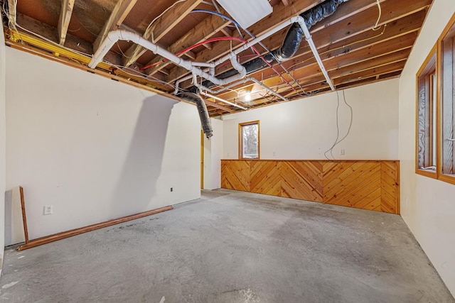 basement featuring wooden walls