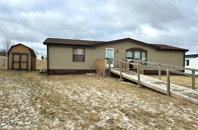 back of house with a shed and a wooden deck