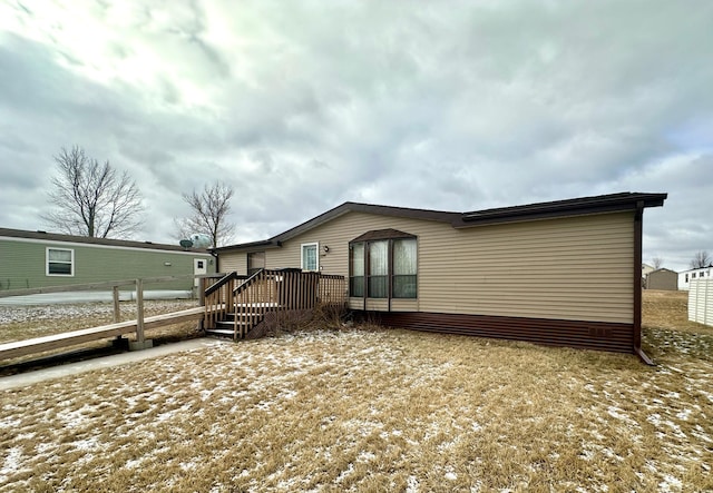 back of house featuring a deck