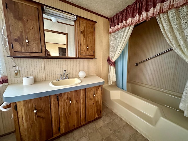 bathroom featuring vanity, shower / bath combo, and a textured ceiling