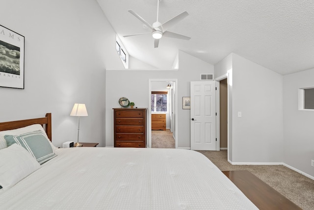 bedroom featuring visible vents, baseboards, carpet, lofted ceiling, and a textured ceiling