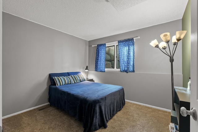 bedroom with baseboards, a textured ceiling, and carpet flooring