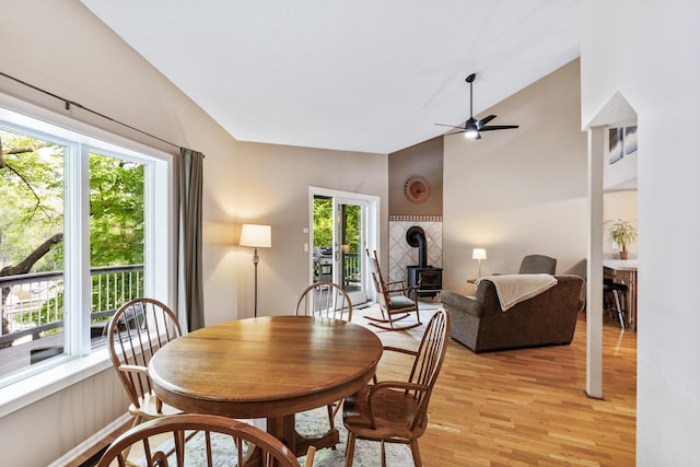 16164 Lakeside Ave SE, Prior Lake, MN 55372 - dining space with a wood stove, plenty of natural light, light wood-style flooring, a ceiling fan, and lofted ceiling