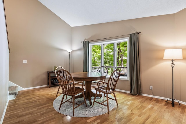 16164 Lakeside Ave SE, Prior Lake, MN 55372 - dining space with light wood-style flooring, baseboards, and lofted ceiling