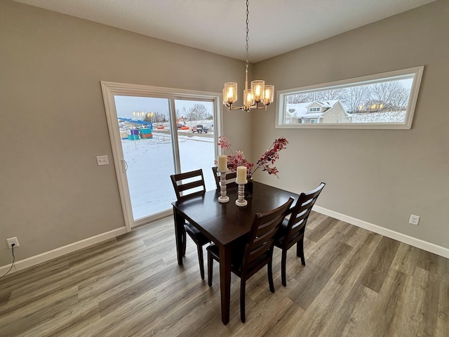 dining area featuring a chandelier and hardwood / wood-style floors