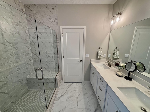 bathroom featuring a shower with door and vanity