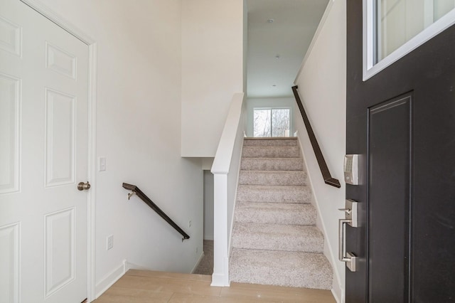 stairs featuring hardwood / wood-style floors