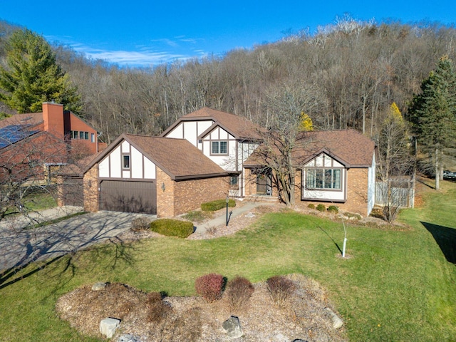 view of front of home with a front yard and a garage