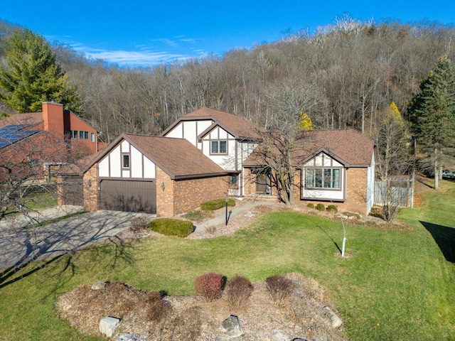 view of front of property featuring a front yard and a garage