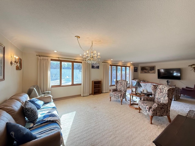 living room featuring light carpet, a textured ceiling, and an inviting chandelier