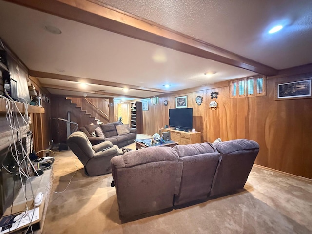 living room with beamed ceiling and wood walls