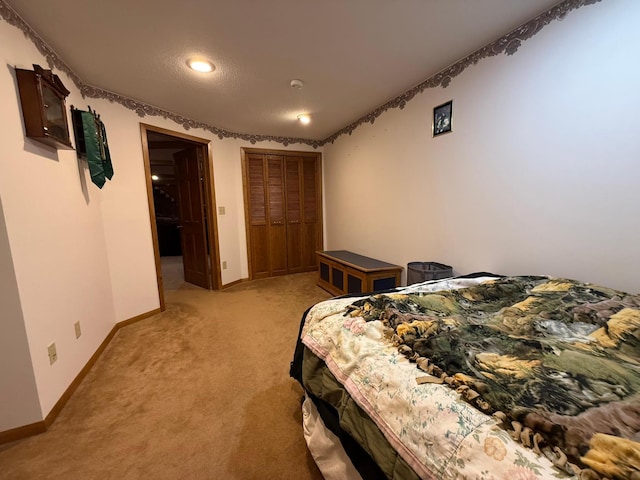 carpeted bedroom with a closet and a textured ceiling